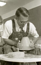 Instructor throwing clay