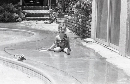 Portrait of young child by the pool
