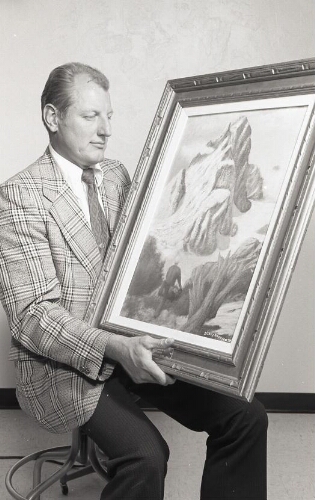 Man holding painting